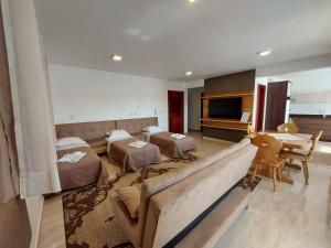a living room with a couch and a table at San Michael Hospedaria in Treze Tílias