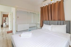 a bedroom with a large bed with white sheets at Munlihouse Cha-Am Hua-Hin Beach in Cha Am +27 photos