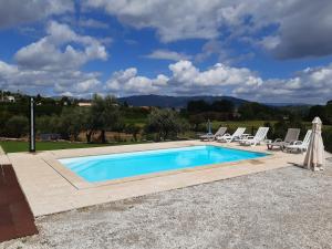 a swimming pool with lounge chairs next to at Quinta do Couto (alojamento local) in Celorico de Basto