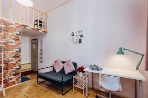 a living room with a chair and a desk at Budapest Three Cats Hostel in Budapest