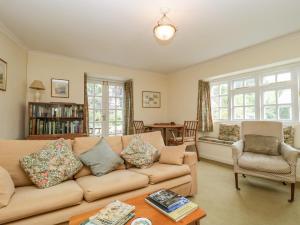 a living room with a couch and a table at Yeoman Cottage in Crewkerne