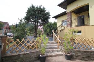 uma cerca em frente a uma casa com algumas plantas em Les Lauriers de la route des vins em Orschwihr