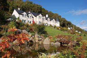 
a small village with a river and houses at Loch Ness Lodge in Drumnadrochit
