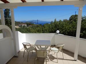 a table and chairs on a balcony with a view at Villa Teozenia in Achladies