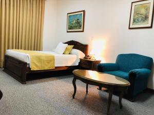 Ένα ή περισσότερα κρεβάτια σε δωμάτιο στο El Gran Hotel de Pereira