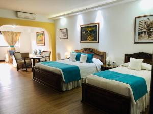 Ένα ή περισσότερα κρεβάτια σε δωμάτιο στο El Gran Hotel de Pereira