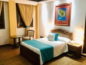 Ένα ή περισσότερα κρεβάτια σε δωμάτιο στο El Gran Hotel de Pereira