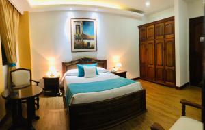 Ένα ή περισσότερα κρεβάτια σε δωμάτιο στο El Gran Hotel de Pereira