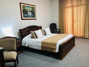 Ένα ή περισσότερα κρεβάτια σε δωμάτιο στο El Gran Hotel de Pereira