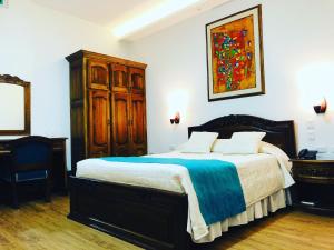 Ένα ή περισσότερα κρεβάτια σε δωμάτιο στο El Gran Hotel de Pereira