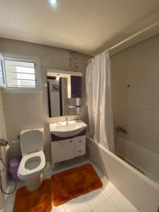 a bathroom with a toilet and a sink and a shower at Residence Les Dunes POOL VIEW 3 Bedroom Apartment in Sousse +18 photos