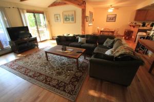 a living room with a couch and a coffee table at Quaint Stowe Cabin in Stowe