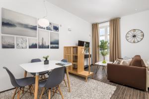 a living room with a table and chairs and a couch at Apartments Harbour View in Rijeka