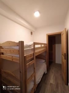 a bunk bed room with two bunk beds in it at Solimmo in Temù