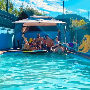 a group of people sitting in a swimming pool at Villa La Perla in Corsanico-Bargecchia