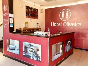 a hotel lobby with a hotel olivia sign at Hotel Oliveira - By UP Hotel in Ipatinga