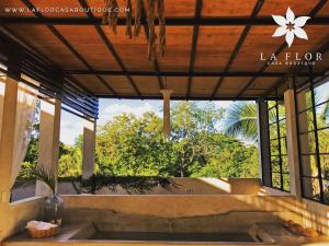 a view from the inside of a house with a large window at La Flor Casa Boutique in Valladolid