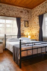 a bedroom with a bed and a stone wall at La Casa Carina in Antalya