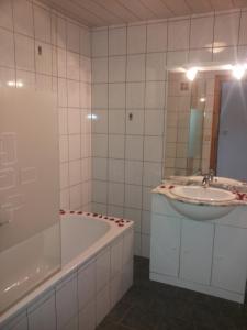 y baño con bañera y lavamanos. en Dirnbergerhof, en Mondsee