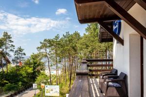 a balcony with chairs and a view of the ocean at Mewa in Sztutowo