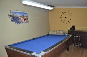 a room with a pool table and a clock on the wall at Casa Rural Consuelo in Alcalá del Júcar