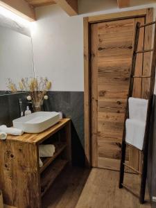 a bathroom with a white sink and a mirror at Au Fond du Bourg VDA Jovencan 0001 - 0002 in Aosta