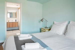 a bedroom with a white bedspread and white pillows at Rossio Hostel in Lisbon