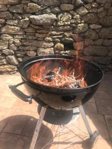 a grill with fire in it on a patio at Finca La Vega in Zamora