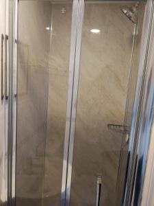 a shower stall with a glass shower door at Regency Hotel in Brighton & Hove