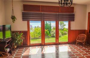 a living room with a large window and a tv at Casa Rural SOBRE EL MAR in Breña Baja