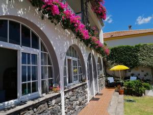 a house with flowers on the side of it at Apartments Vista Oceano in Funchal