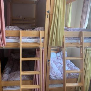 a group of bunk beds in a room at Guesthouse Zink in Sado