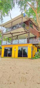 a yellow building with a balcony on top of it at Maya guest house@coffee in Ko Chang