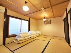 a living room with white chairs and a window at 古都庵 Japanese Town house in Kyoto