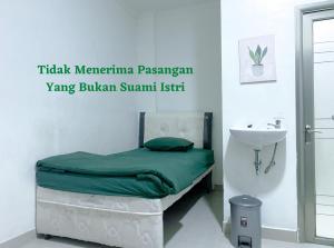 Letto o letti in una camera di Anugrah Inn