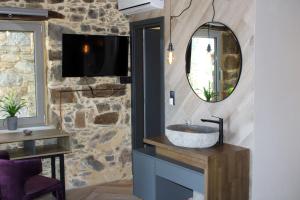 a bathroom with a sink and a mirror at INO II Domus by Amigdalokefali Elafonissi in AmigdhalokeFálion