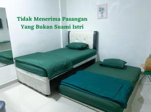 Letto o letti in una camera di Anugrah Inn