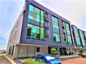 a blue car parked in front of a building at Prestigo Hotel - Johor Bharu in Johor Bahru