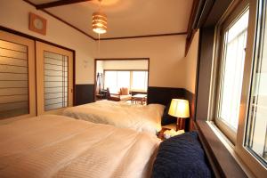 Un pat sau paturi într-o cameră la kODATEL コダテル函館ウエストサイド