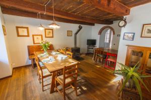 a dining room with a table and chairs at Casa Tomà in Masera