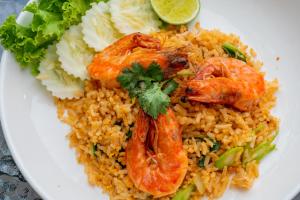 a white plate of food with shrimp and rice at Sky Hip Resort - SHA Certified in Jomtien Beach