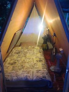 a bedroom with a bed in a tent at KhonThao in Lamphun