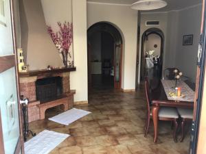 a living room with a table and a fireplace at IL TUCANO in Pergusa
