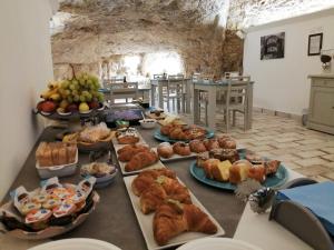 a table filled with lots of different types of food at Casa dell'Aromatario b&b in Sciacca