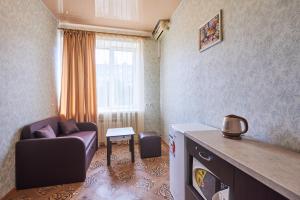 a living room with a couch and a window at Хостел Perron in Kharkiv