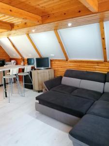 a living room with a couch and a table at Fábián Apartman in Tata