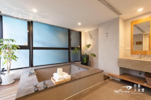 a bathroom with a large tub and a sink at ISPAVITA B&B Resort in Jiaoxi +37 photos