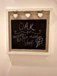 a chalkboard with a sign that says oak welcomes your stay at The Family Tree in Whatstandwell