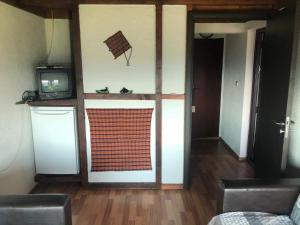 a room with a kitchen and a television and a door at Александрова вила 1 in Zlatograd +97 photos