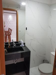 a bathroom with a black sink and a toilet at Luxury Duplex Casa in Natal +40 photos